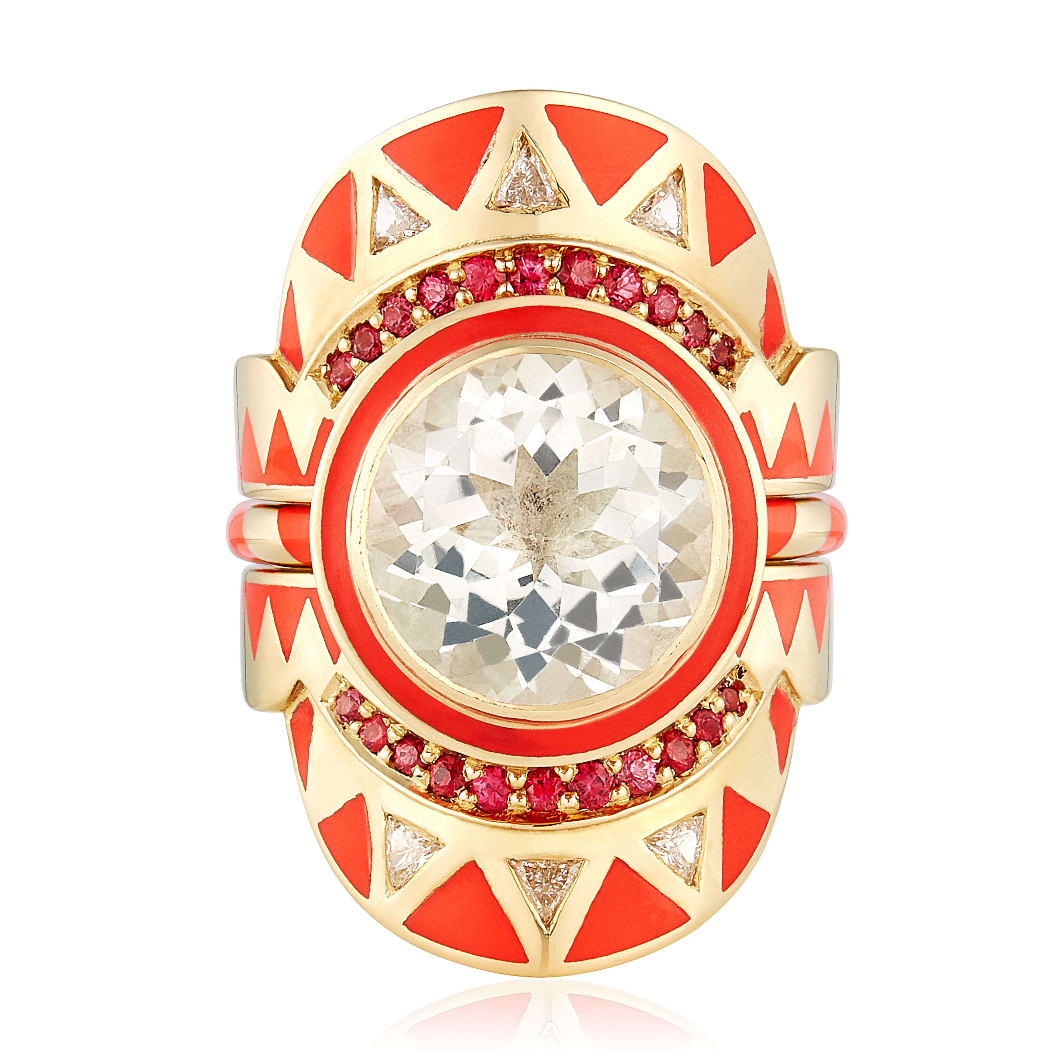 fashion jewellery trends 2025 - A bold gold ring with a central round gemstone, red enamel geometric patterns, red gemstone halo, and diamond accents.