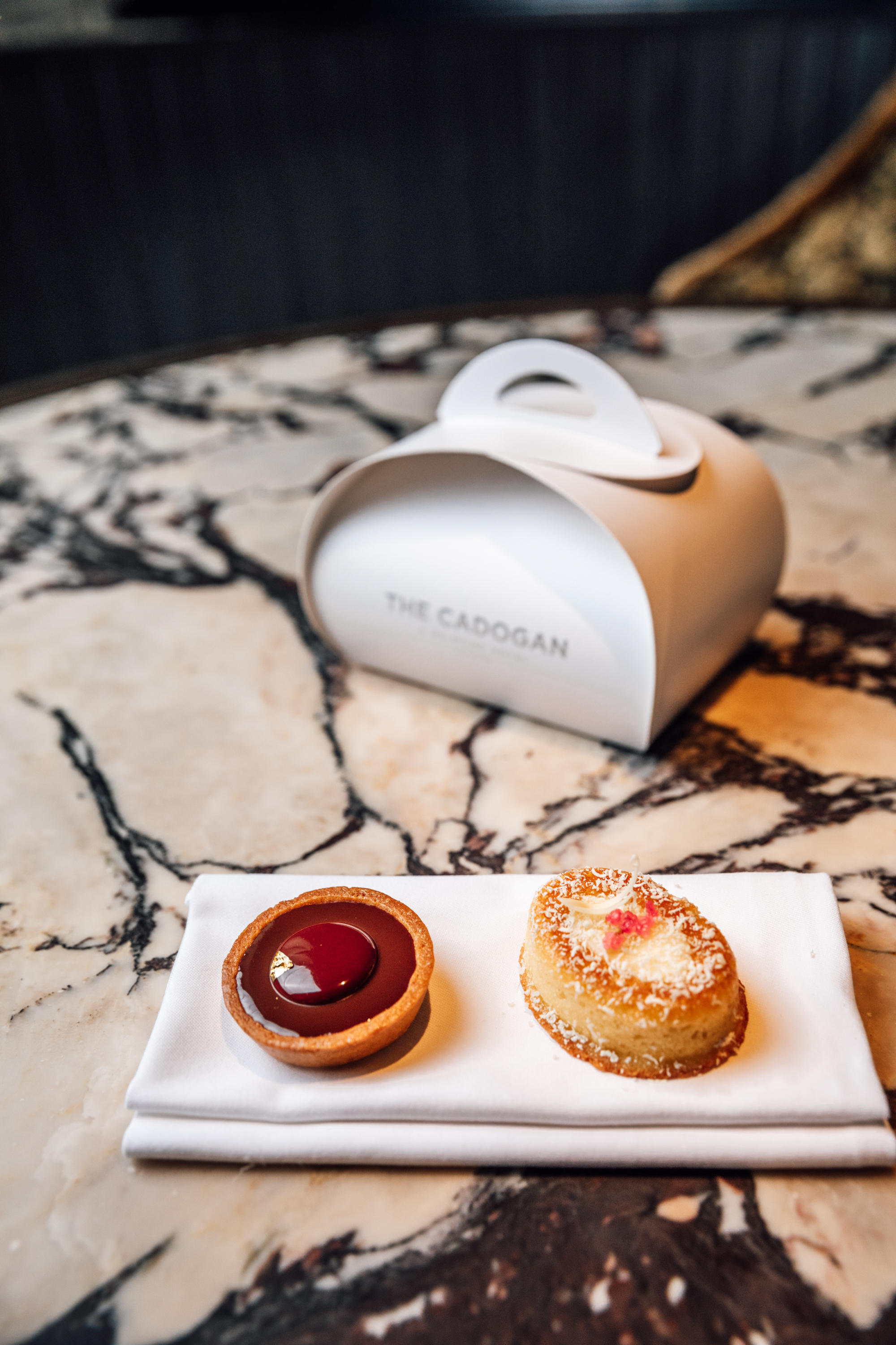 Royal Ascot Restaurants 2025 - a small tart and a cake on a white napkin