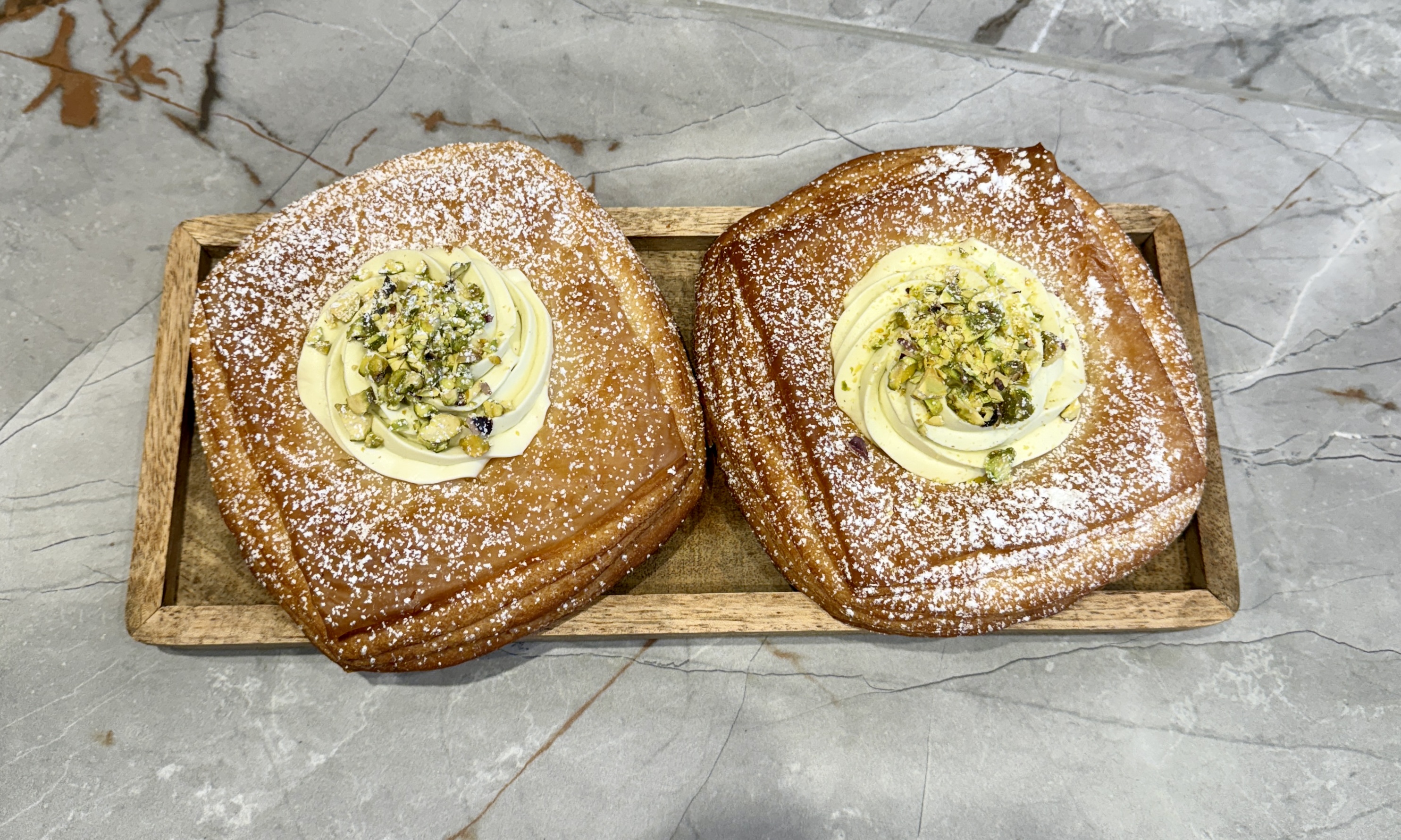 london artisanal bakeries - two cream filled pastries with crushed nuts