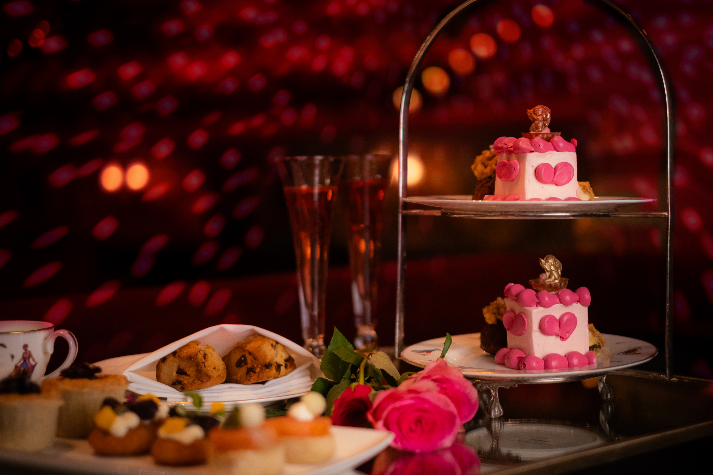 Theatre Royal Season of Love Afternoon Tea - pink sponge cake alongside scones and flutes of pink champagne