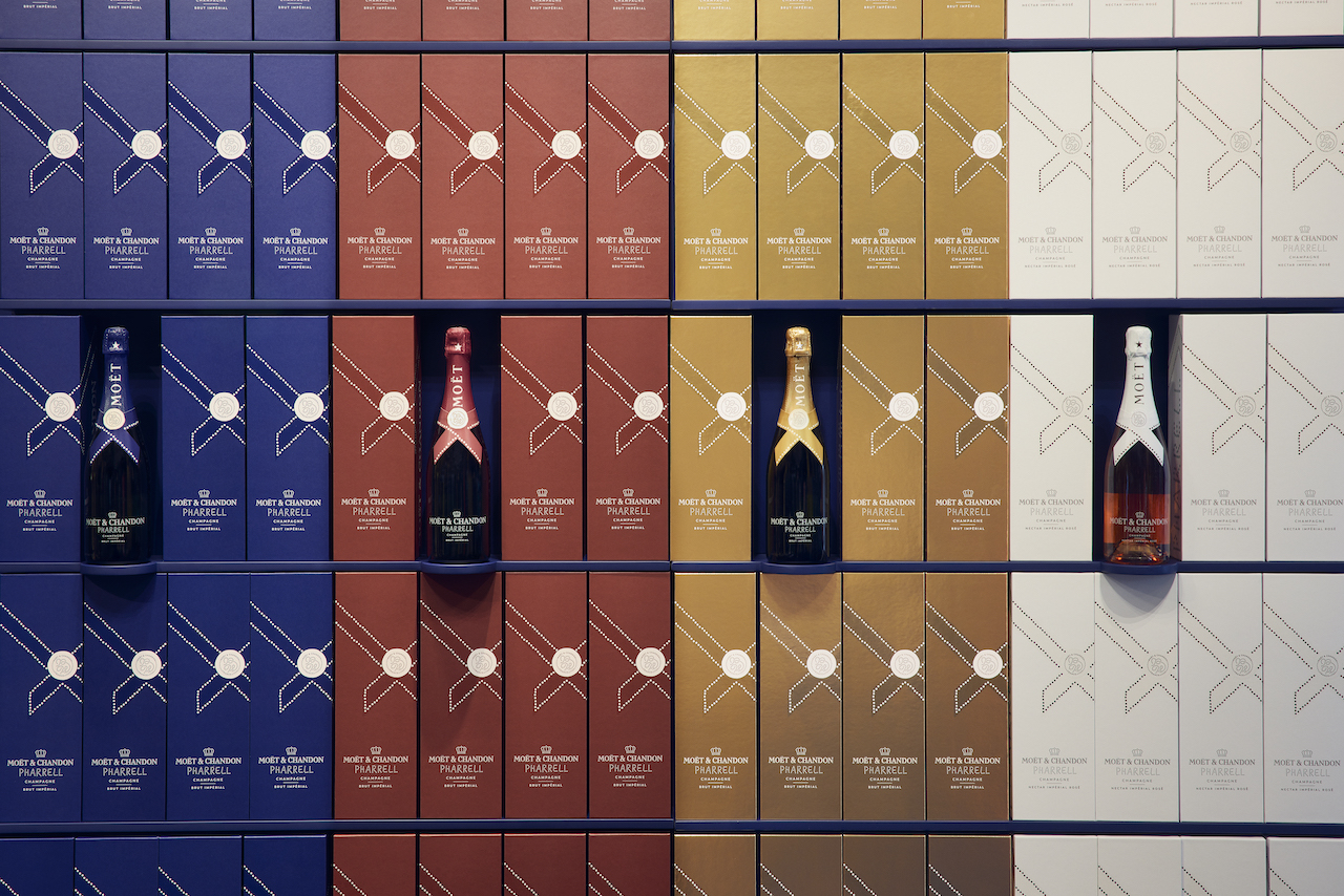 Pharrell Moët & Chandon Harrods Pop-Up - stacks of Moët & Chandon Brut Impérial Limited Edition Gift Boxes, in Midnight Blue, Gold, and Deep Red