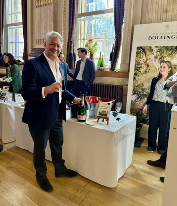 Mentzendorff Annual Tasting - Managing Director Justin Liddle with a bottle of Champagne Bollinger