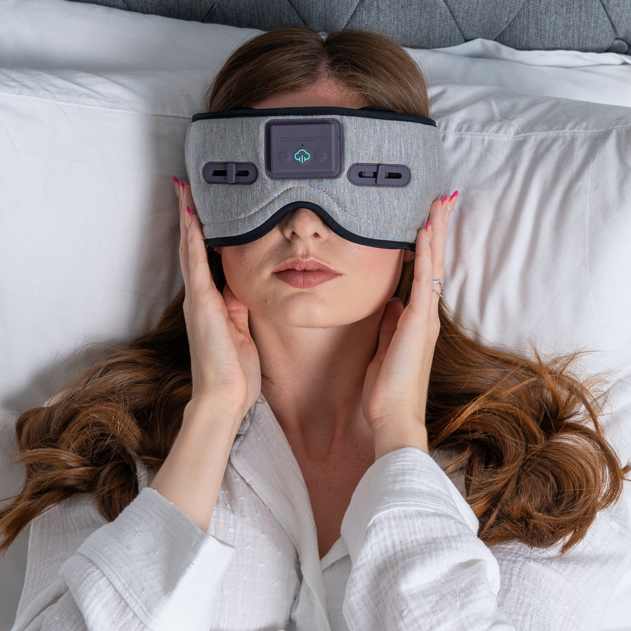 Effective Products Deeper Sleep - a woman lying down on white pillows with a grey sleep mask on