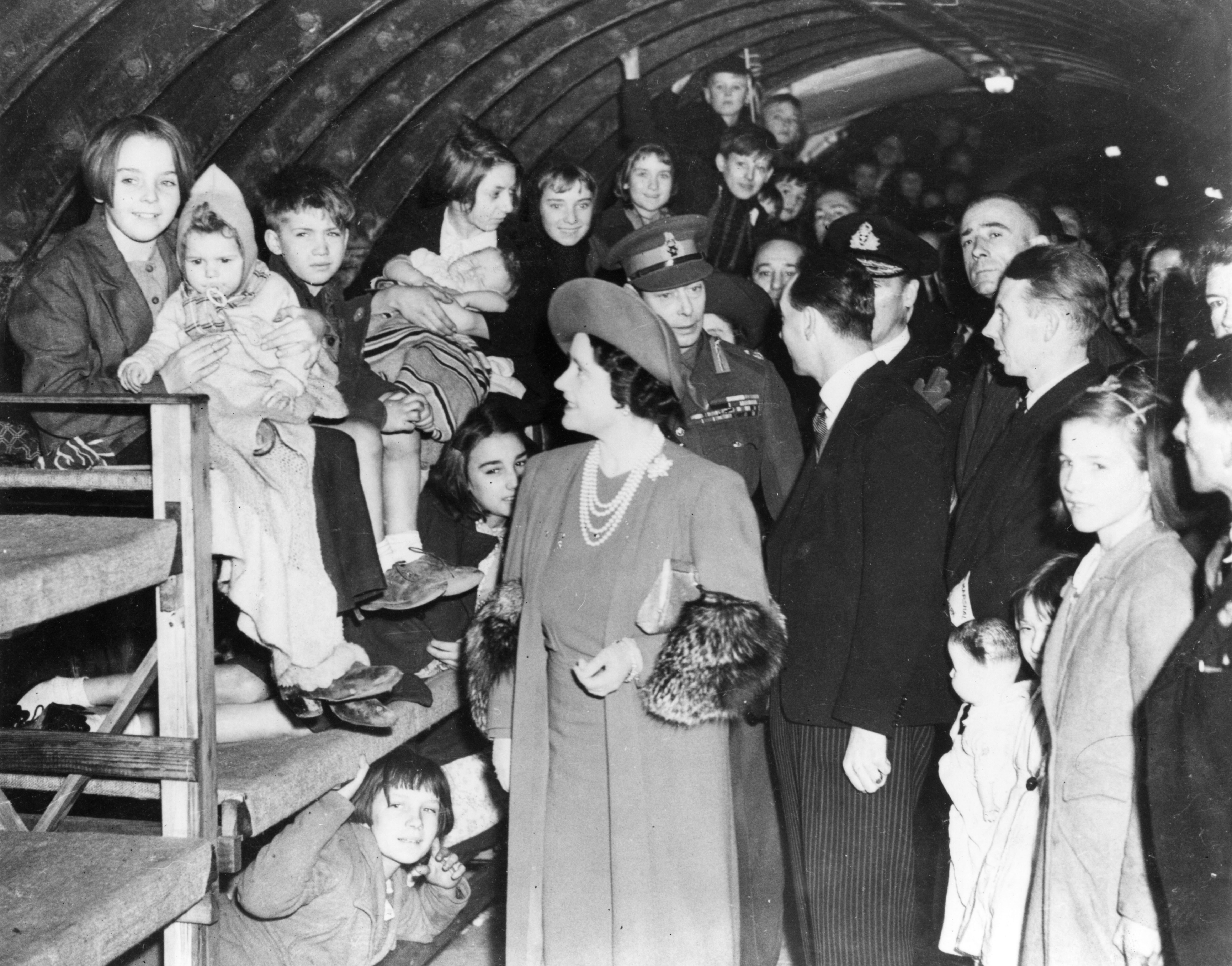 An image of the King and Queen visiting the North Southwark deep air raid shelter.