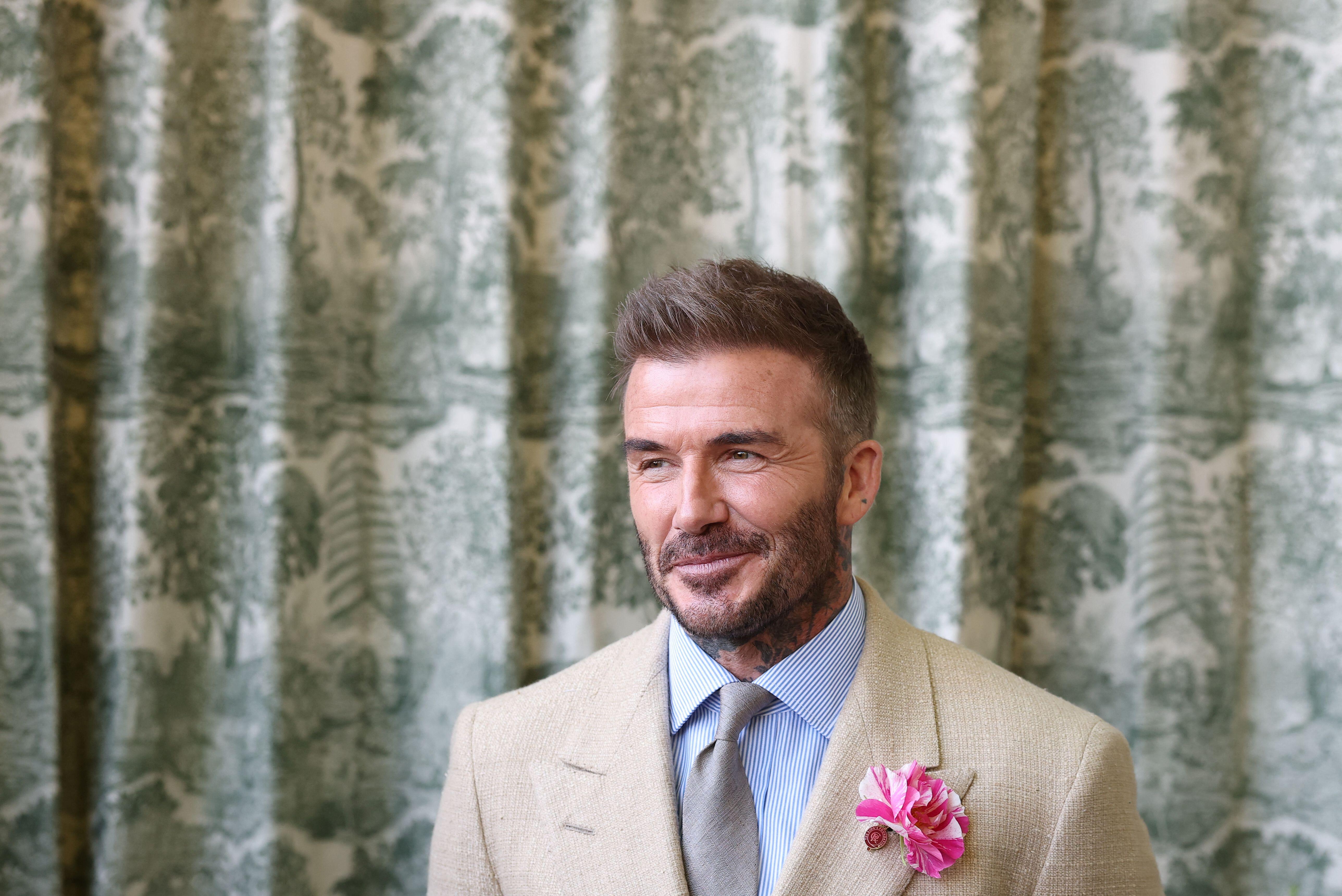 David Beckham wearing the King's Rose on his blazer.