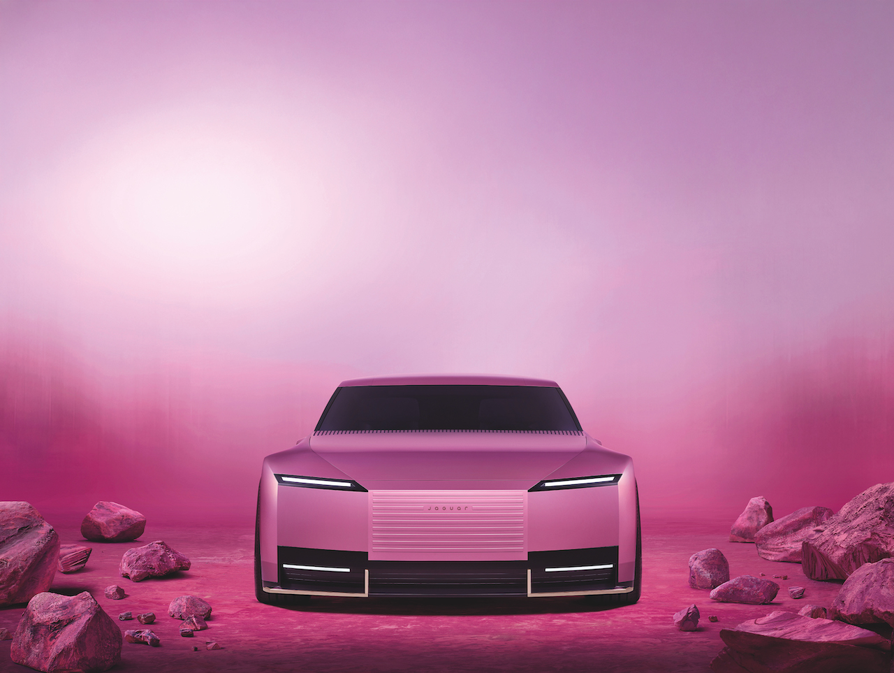 Heritage Car Rebrands - Jaguar's Type 00 concept car in pink in a pink rocky setting.