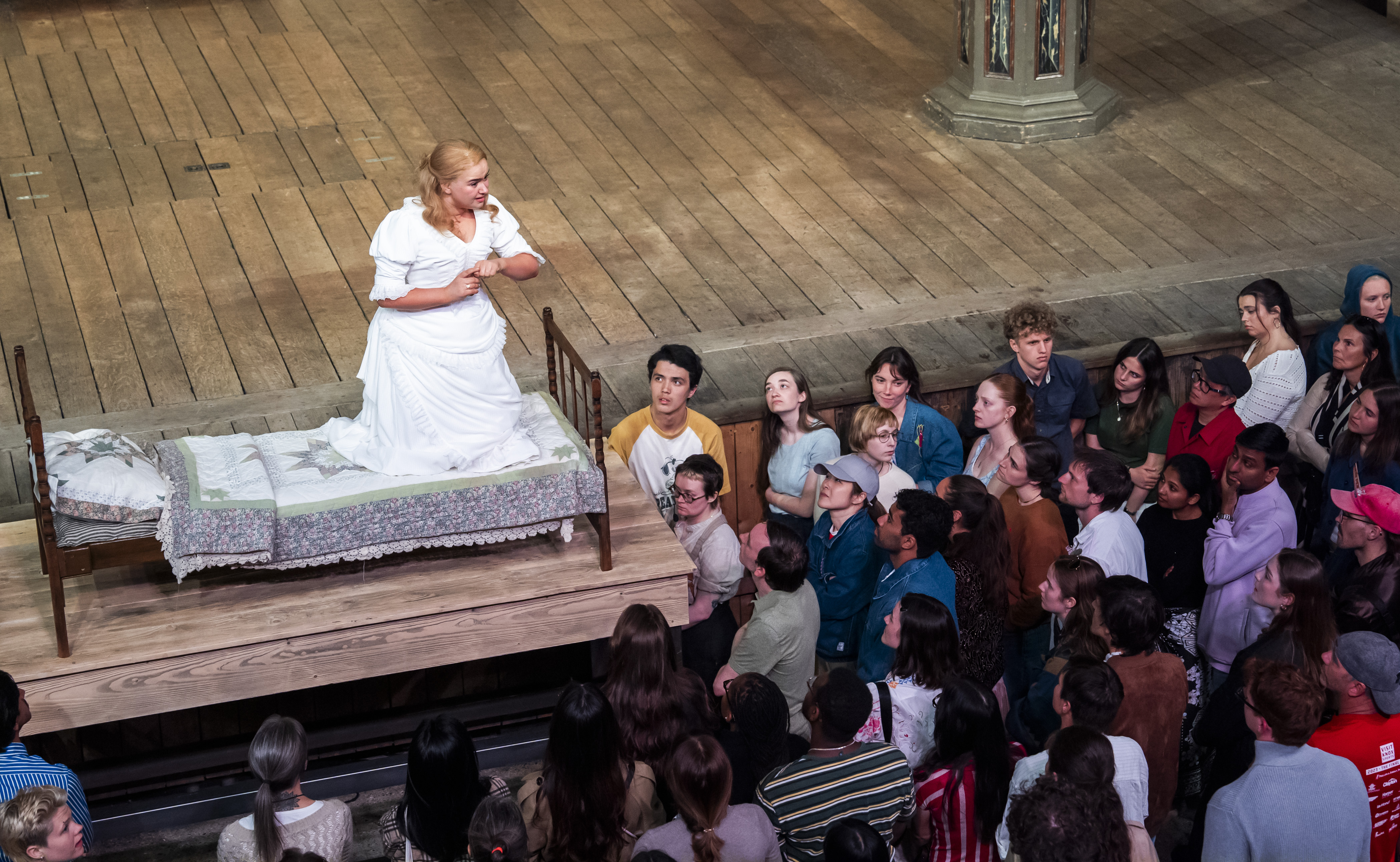 Romeo and Juliet at Shakespeare's Globe - Lola Shalam as Juliet in Romeo and Juliet on a wooden platform.