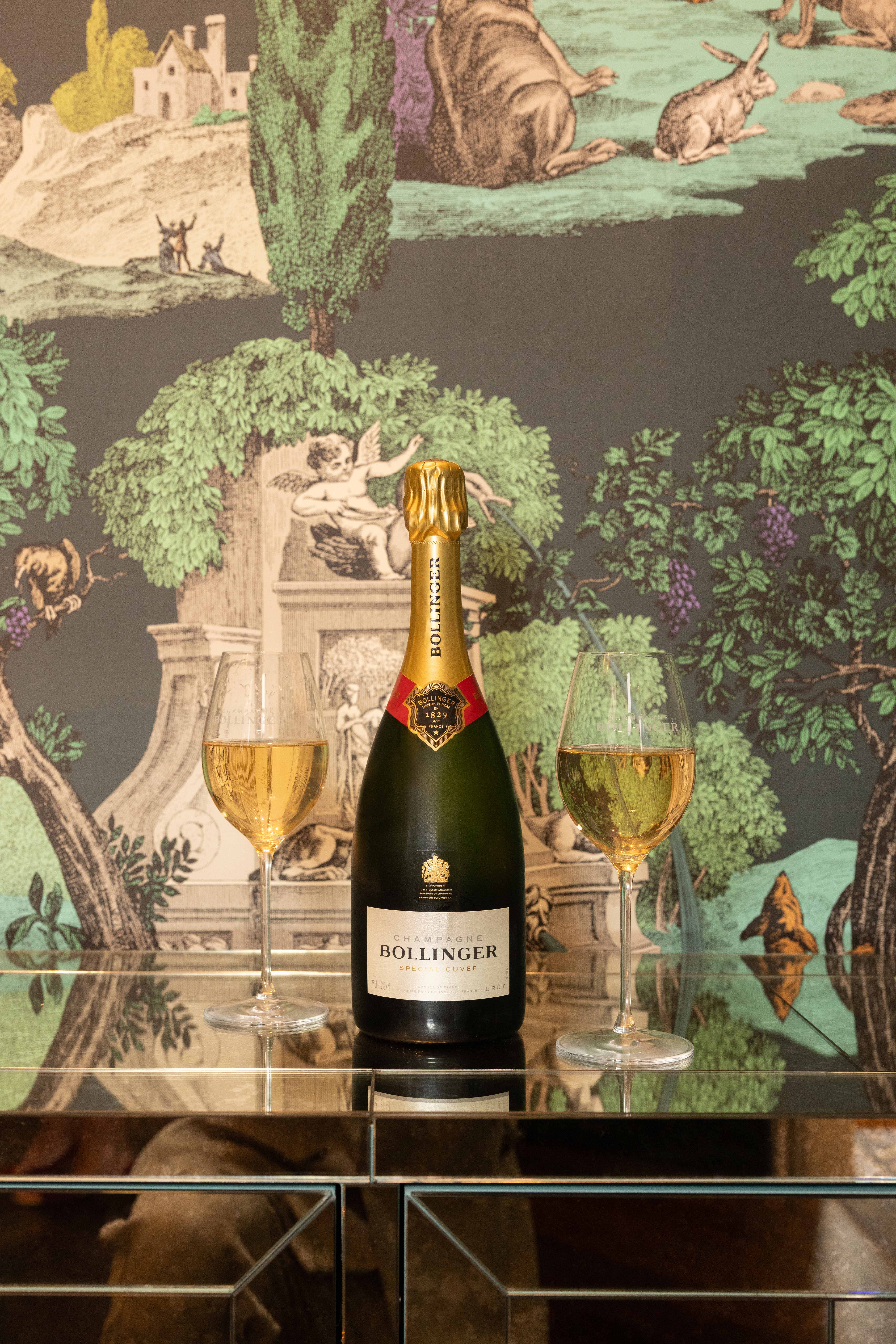 Bollinger in front of wallpaper at the Cole & Son tastemakers event.
