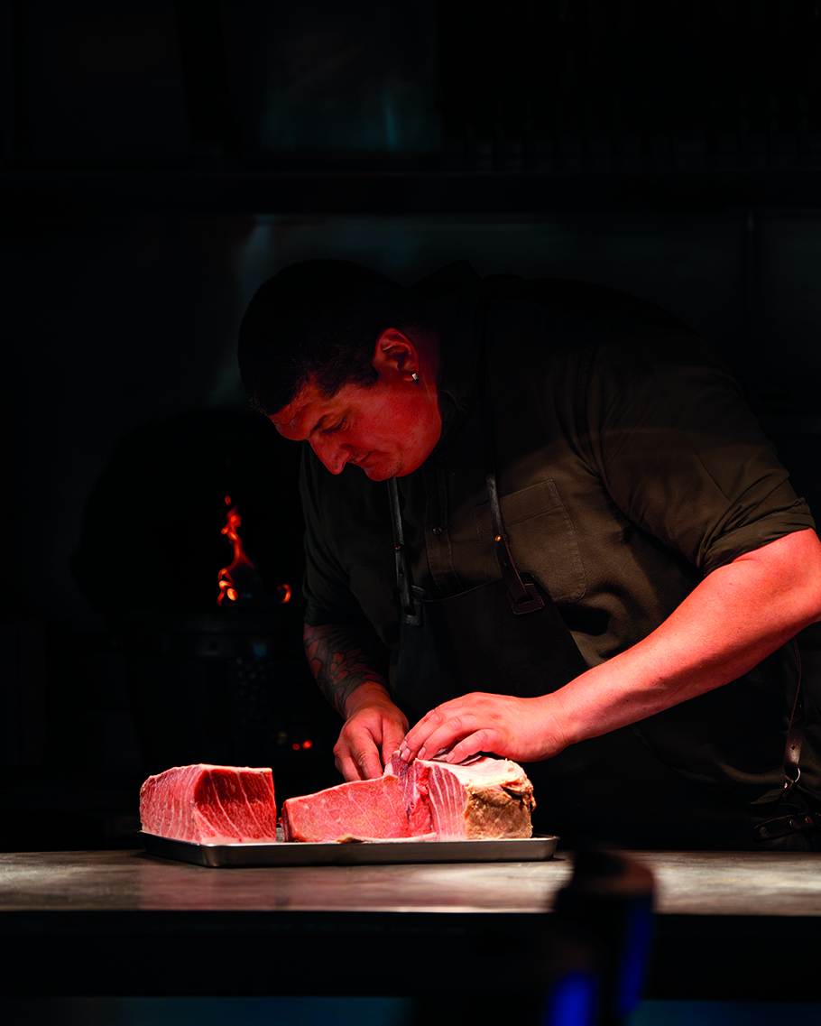 Chef preparing cuts of meat at Ynyshir.