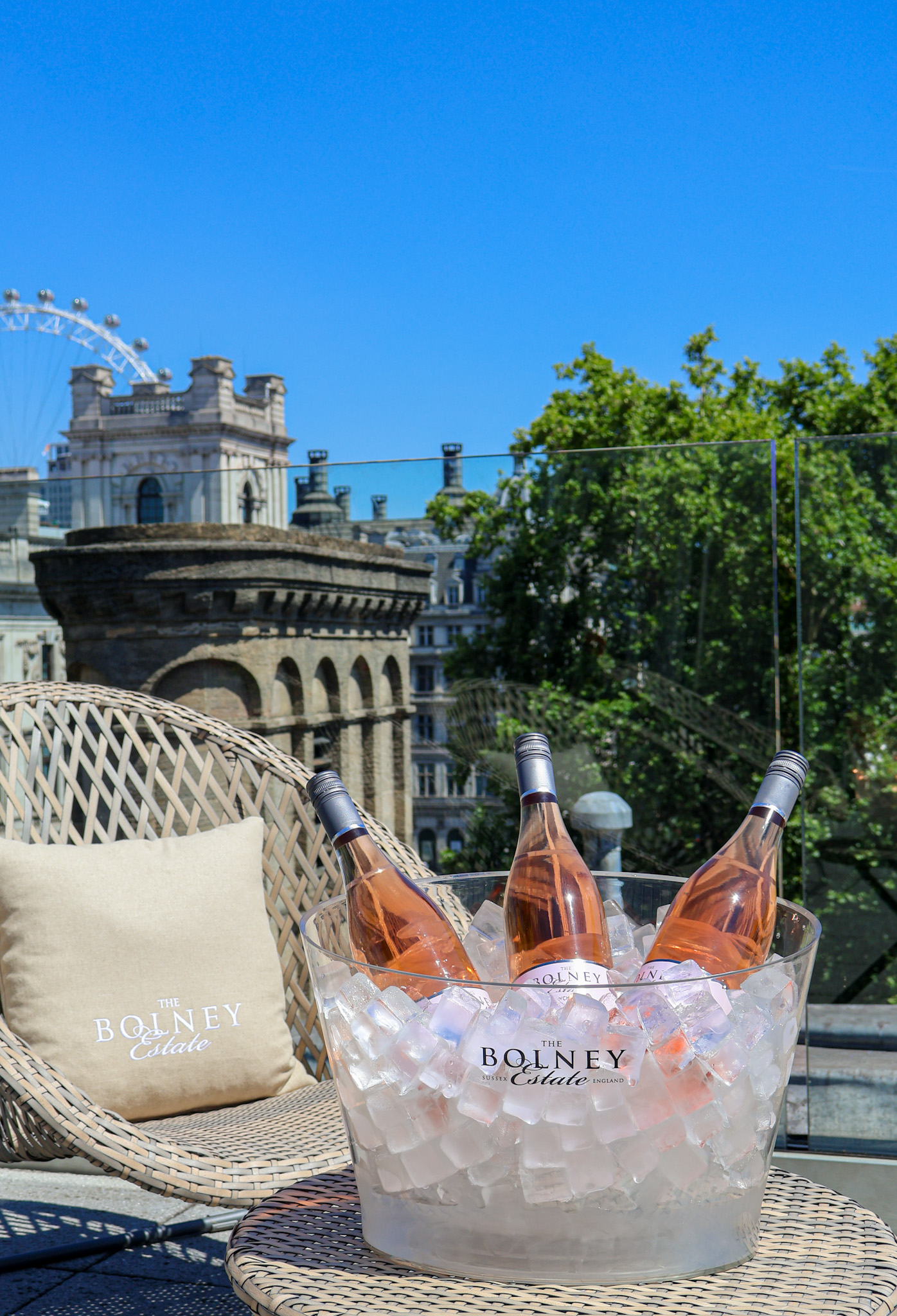 A wicker chair on a rooftop at Searcys overlooking the London Eye.