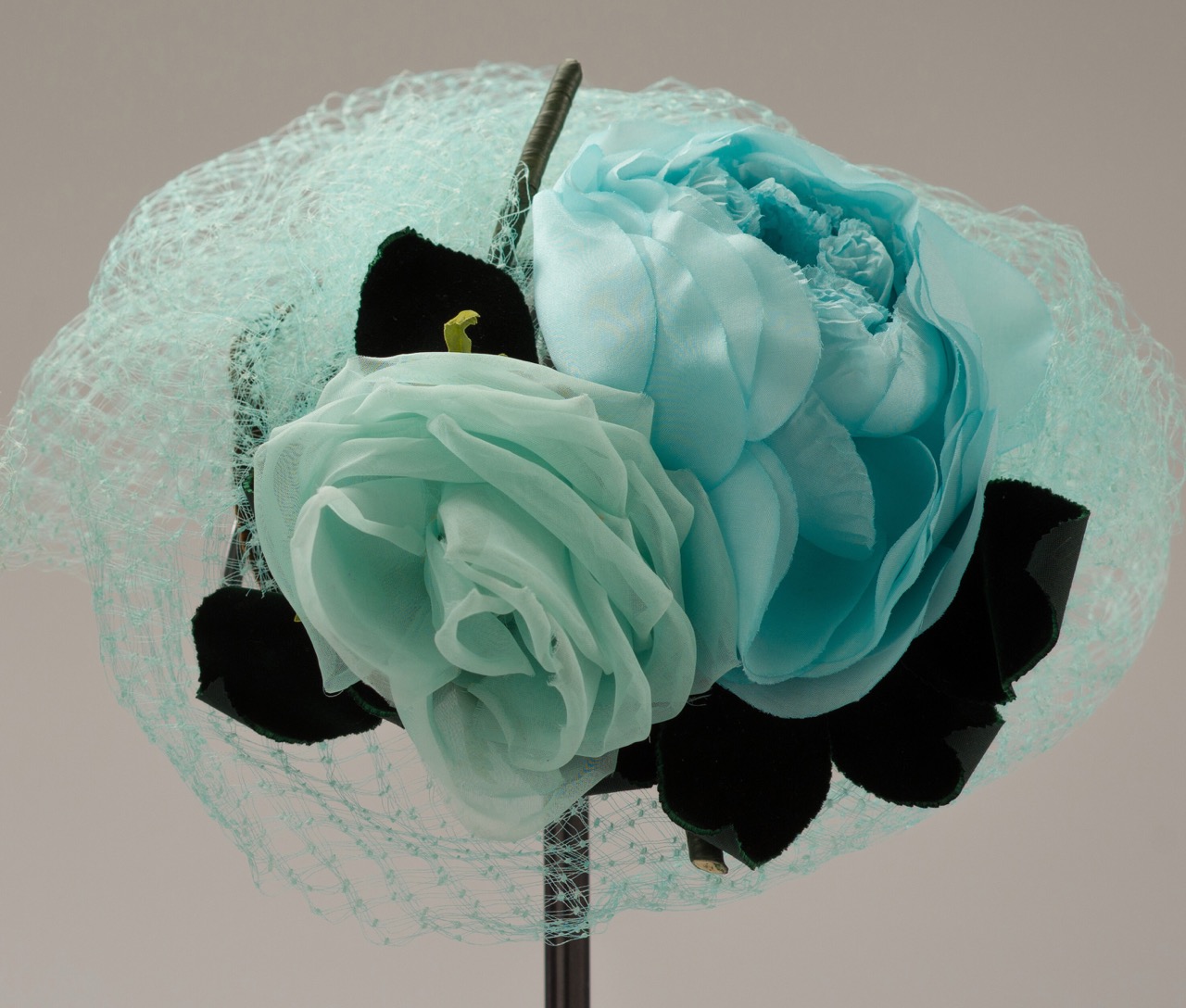 Royal Fashion is all about the accessories, see the turquoise rose hat.