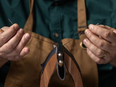 Swaine artisan sewing at their workshop.