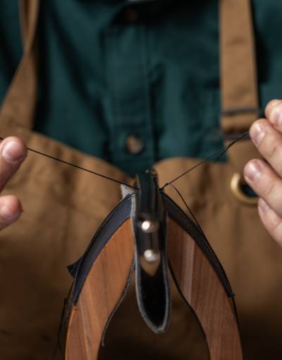 Swaine artisan sewing at their workshop.